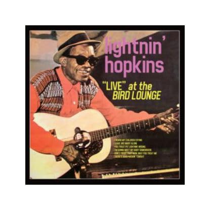 Lightnin’ Hopkins album cover, showing him playing an acoustic guitar.