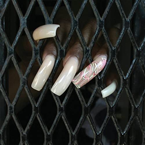 Hand with long, decorated nails pressed against a metal grate.