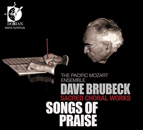 CD cover featuring Dave Brubeck writing music, black background.