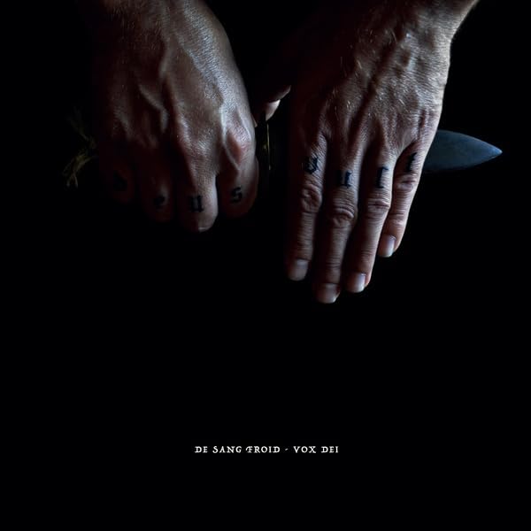 Hands with tattoos holding a knife against a dark background.