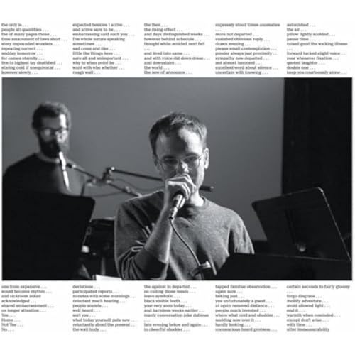 Black and white album cover featuring two men with microphones and instruments.