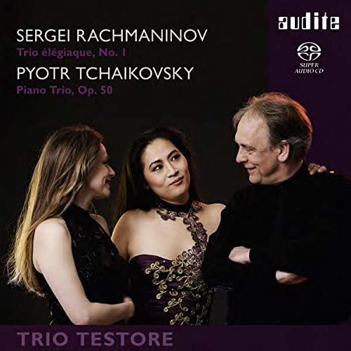 CD cover featuring three musicians, a woman in a patterned dress, and text.