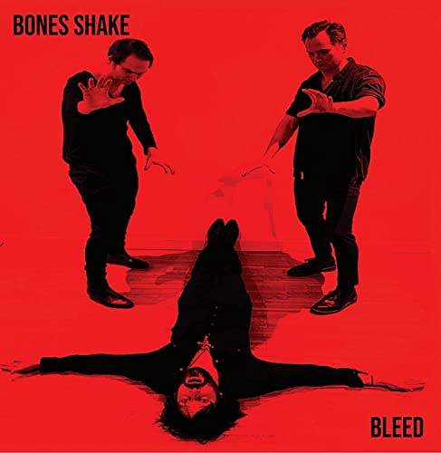 Red album cover featuring two men and a person lying prone.