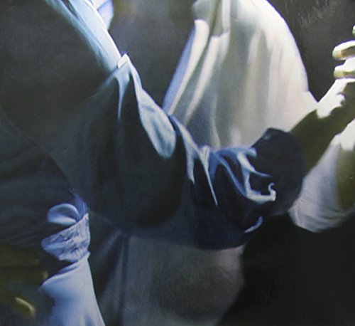 Close-up of a person in white clothing, partially obscured in shadow.