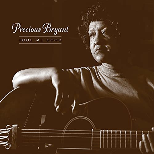 Sepia-toned portrait of Precious Bryant with an acoustic guitar.