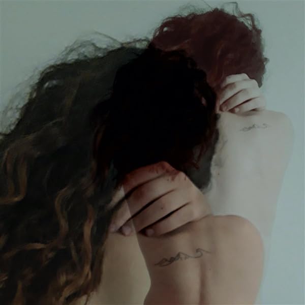 Two people with curly hair embrace from behind, backs to viewer.