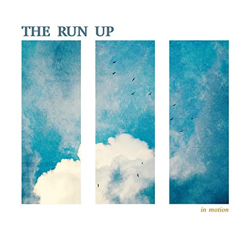 Album cover with blue sky, white clouds, and silhouetted birds.