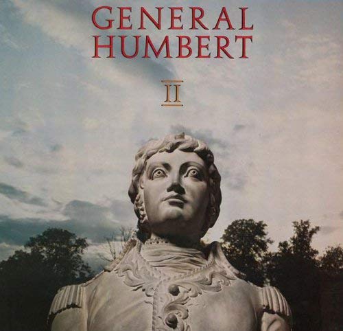 A stone bust of General Humbert against a cloudy sky with text above.