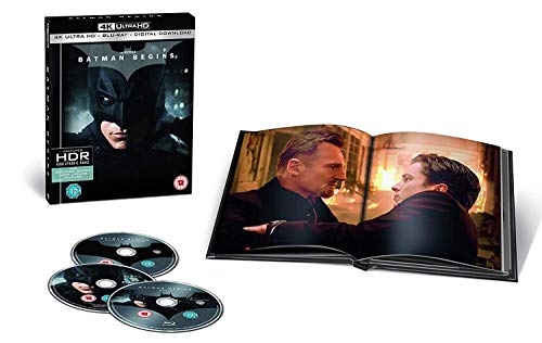 Batman Begins" 4K Blu-ray case with discs and open art book.