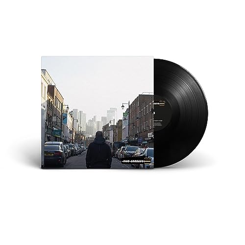 Vinyl record with album cover showing a person walking down a street.