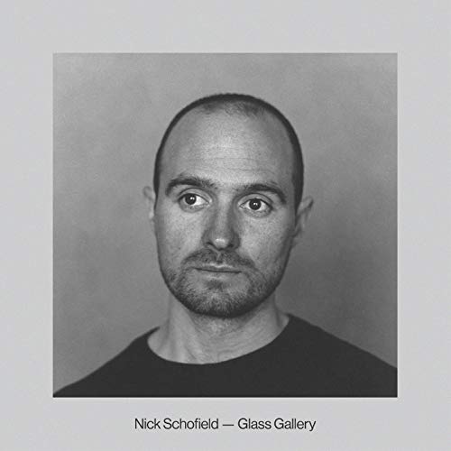 Black and white portrait of a man with a beard, album cover.