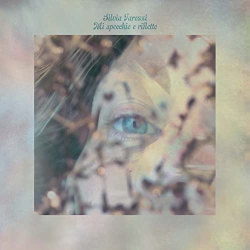 CD cover: close-up of an eye reflected in textured, blurred branches.