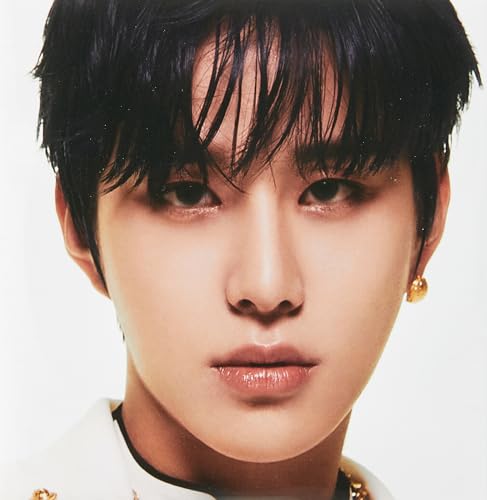 Close-up portrait of a young man with dark hair and a white shirt.