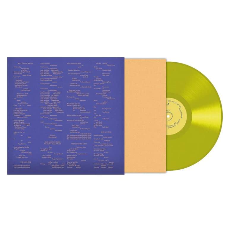 Tom Odell vinyl record, yellow disc with lyric sleeve, open flat.