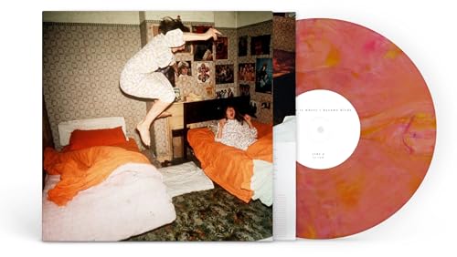 Vinyl record with guava swirl and album cover featuring a jumping figure.