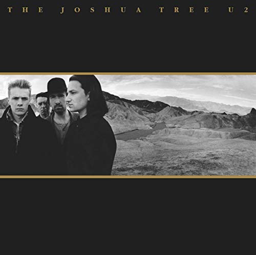 U2’s “The Joshua Tree” album cover: band portrait with desert landscape.