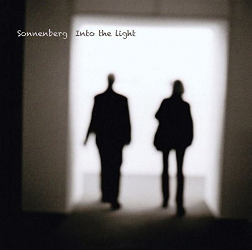 CD cover: Silhouettes of two figures walking toward a bright doorway.