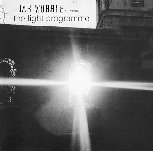 Black and white album cover with a bright light beam and arches.