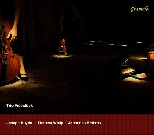 CD cover featuring musicians with cello, violin, and a piano in shadow.