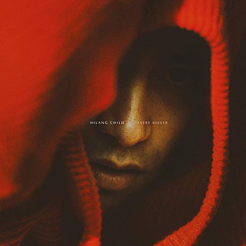 Close-up of a person’s face partially obscured by red fabric.