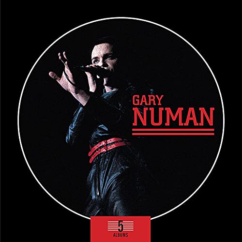 Gary Numan singing on stage inside a circular frame with red text.