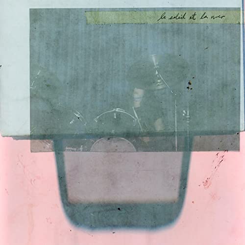 Vinyl record cover with a blurred image of a drummer playing.