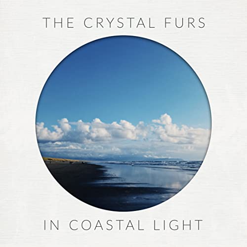 Album cover with a circular photo of a beach under a blue sky.