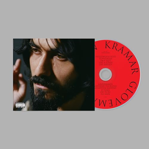 CD case with portrait of bearded man and red disc beside it.
