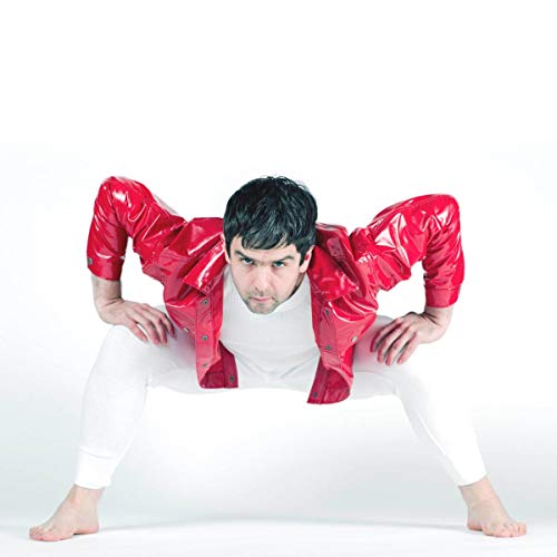 Man in red plastic suit, crouching with arms outstretched.
