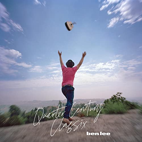 Album cover: person with raised arms under a hat and blue sky.