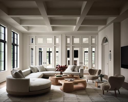 Bright, modern living room with neutral furniture and large windows.