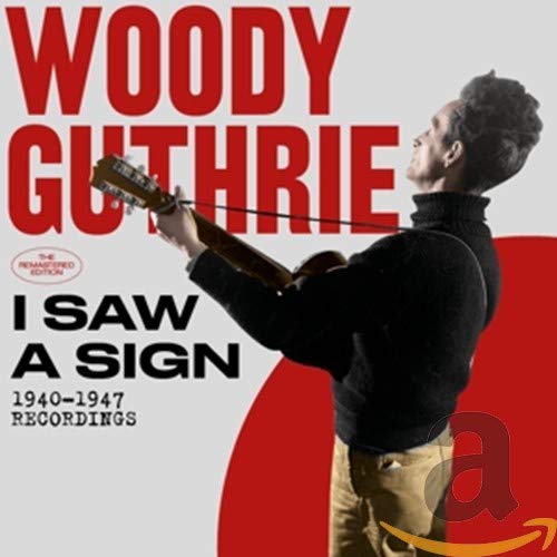 Woody Guthrie album cover featuring him playing guitar, red and white design.
