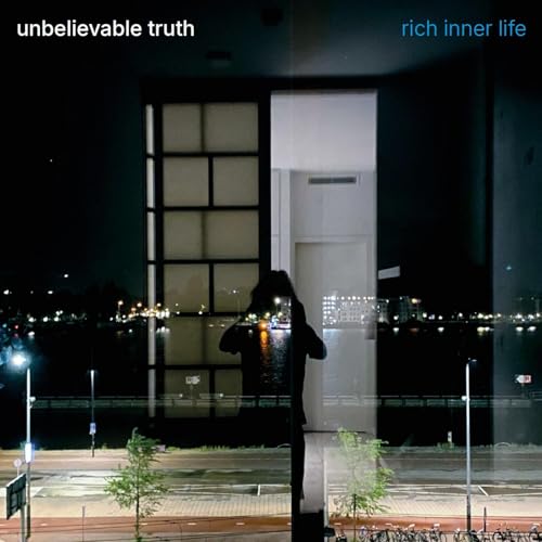 CD cover: dark building exterior with a silhouetted figure looking in.