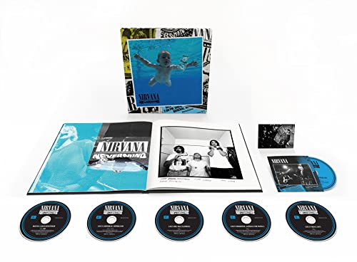 Nirvana’s “Nevermind” CD reissue with bonus discs and photographs laid out.