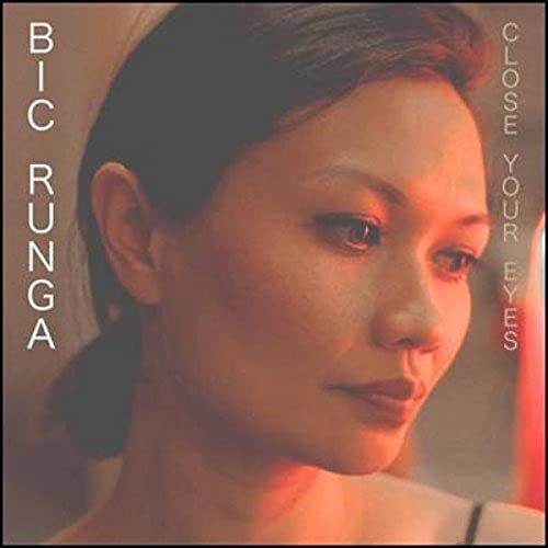 CD cover: Portrait of a woman with closed eyes, warm tones.