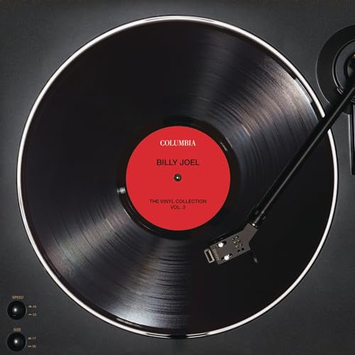 Billy Joel vinyl record on a turntable, red label visible.