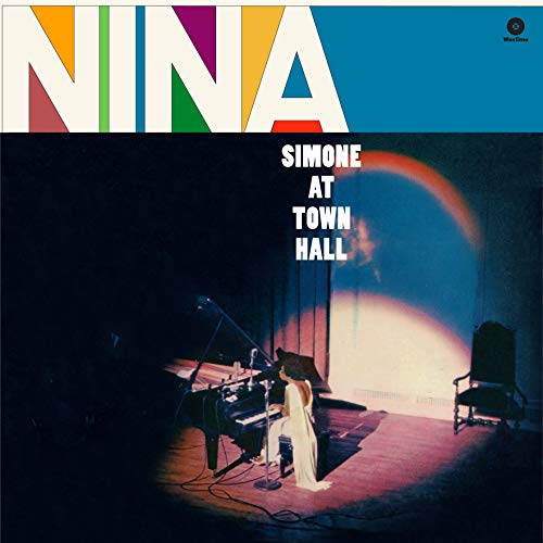 Nina Simone performing at a piano on stage under a spotlight, album cover art.