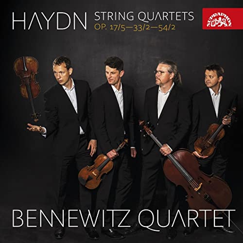 CDSSLSFour men in black suits holding string instruments on a dark background.
