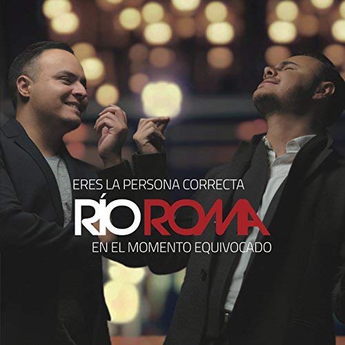 Two men, Rio Roma, looking in opposite directions with album title overlay.