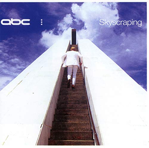 Album cover: man in white ascending endless stairs toward clouds.