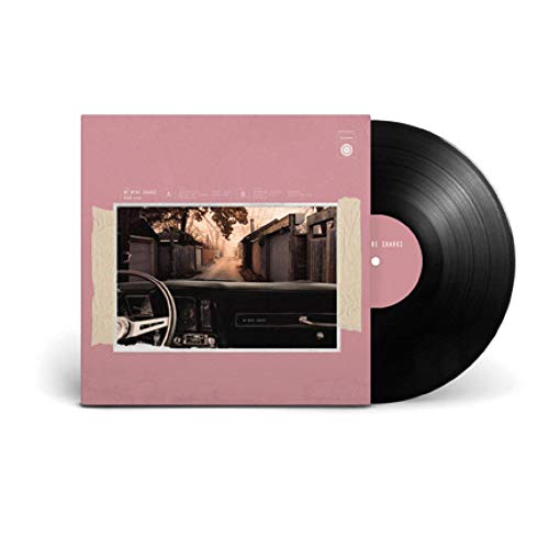 Vinyl record with a pink album cover featuring a car dashboard scene.