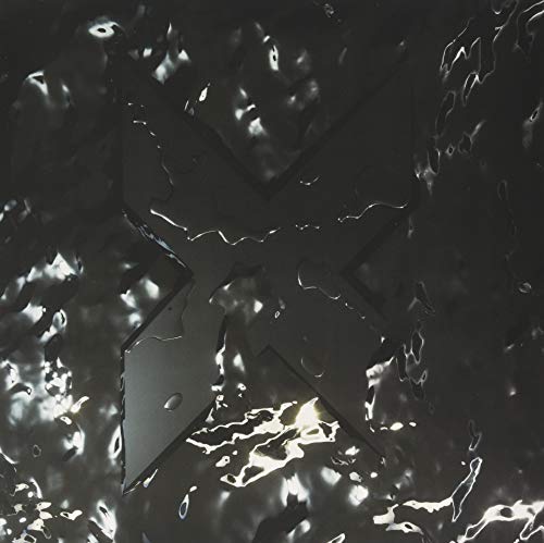 Black vinyl record cover with a large, textured "X" design.