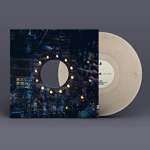 Vinyl record with cover art featuring a dark, abstract cityscape.