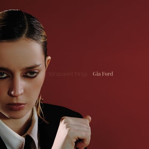 Close-up portrait of Gia Ford on a red background, album cover.