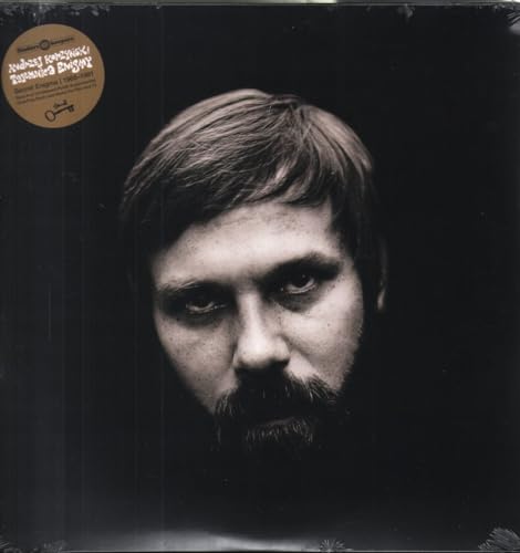 Black vinyl record cover featuring a close-up portrait of a bearded man.