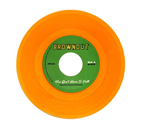 Orange vinyl record with green label, displaying song titles and artist names.