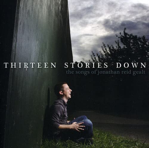 CD cover: man laughing near a large, dark green wall.