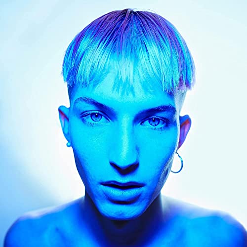 Close-up portrait of Gus Dapperton with blue hair and piercing eyes.