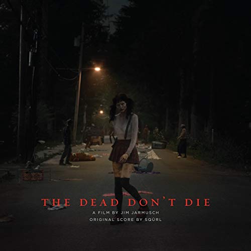 Vinyl album cover for “The Dead Don’t Die” featuring a woman on a road.