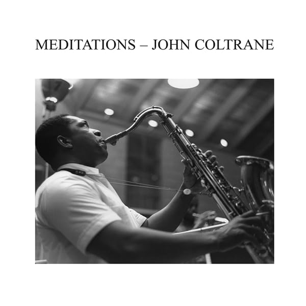 Black and white photo of John Coltrane playing a saxophone.